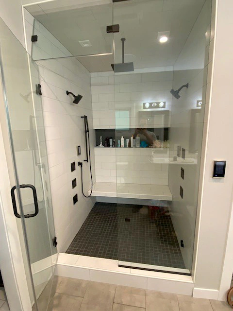 A bathroom remodel with a new accessible, walk-in shower and double showerheads from Niebuhr Plumbing, Heating, and Air Conditioning in La Crosse, WI.