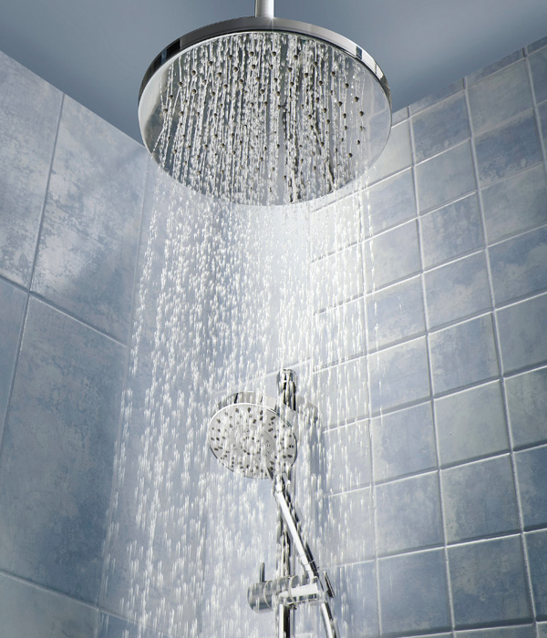 Water falling from a rain showerhead in the bathroom.