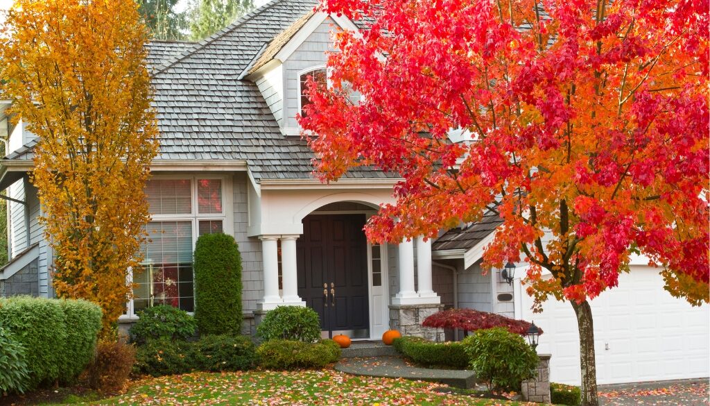 Charming Midwest residential home surrounded by vibrant fall foliage