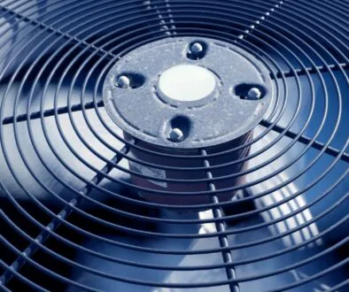 Close-up of an outdoor air conditioning unit fan.