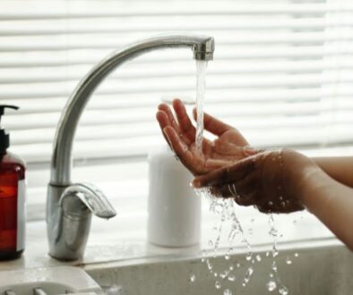 niebuhr-plumbing-heating-air-conditioning-what-slows-down-water-heater-and-delays-hot-water-hands-under-faucet