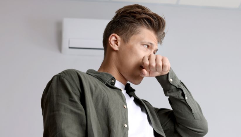 niebuhr-plumbing-heating-air-conditioning-why-AC-smell-when-you-turn-it-on-man-covering-nose