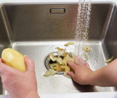 Homeowner disposes of potato peels after learning what should never go down a garbage disposal.